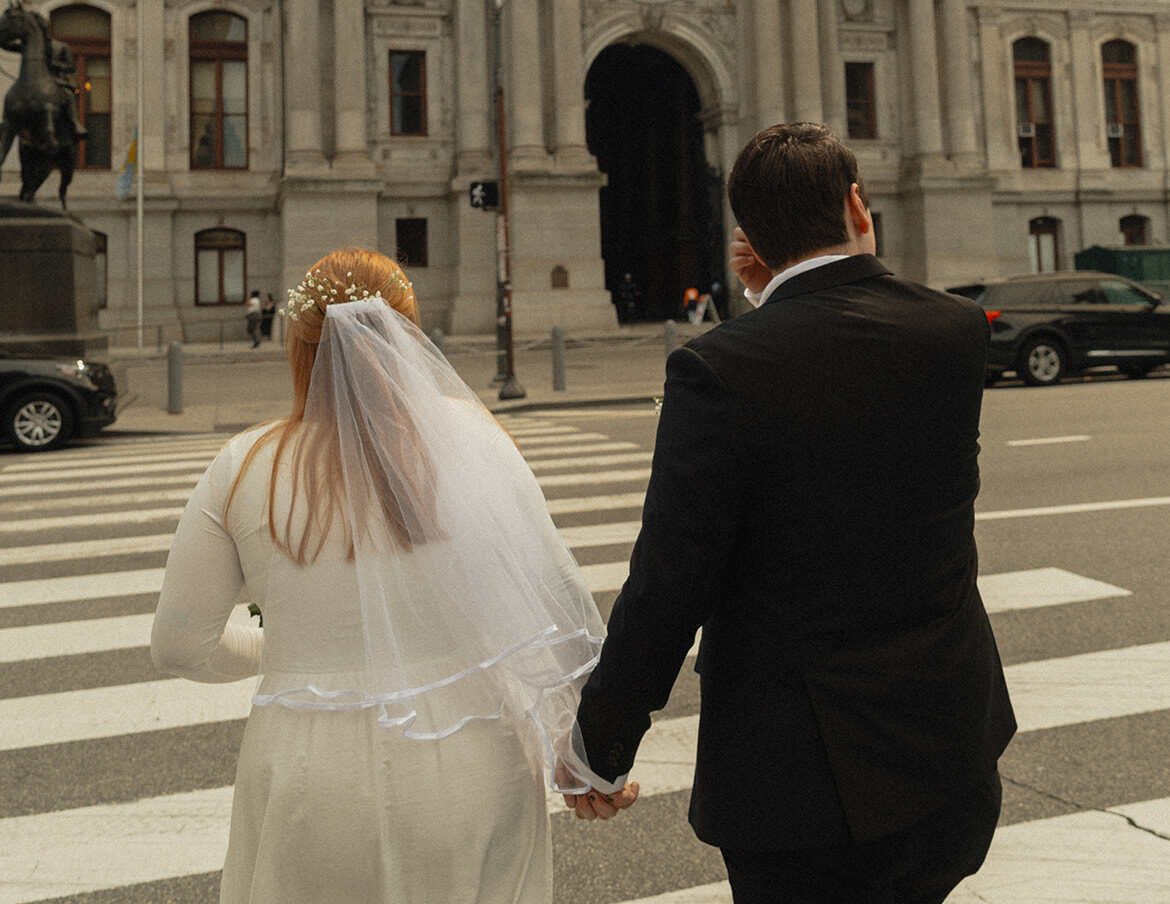 couple walking to philadelphia city hall