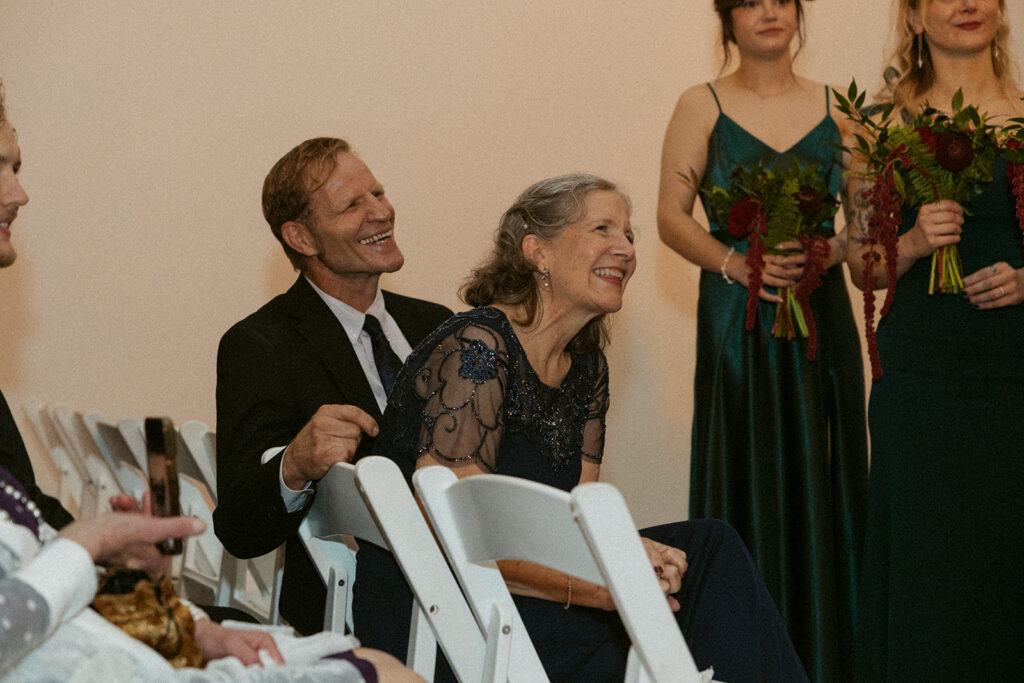 couple's parents laughing during ceremony, a second photographer's image