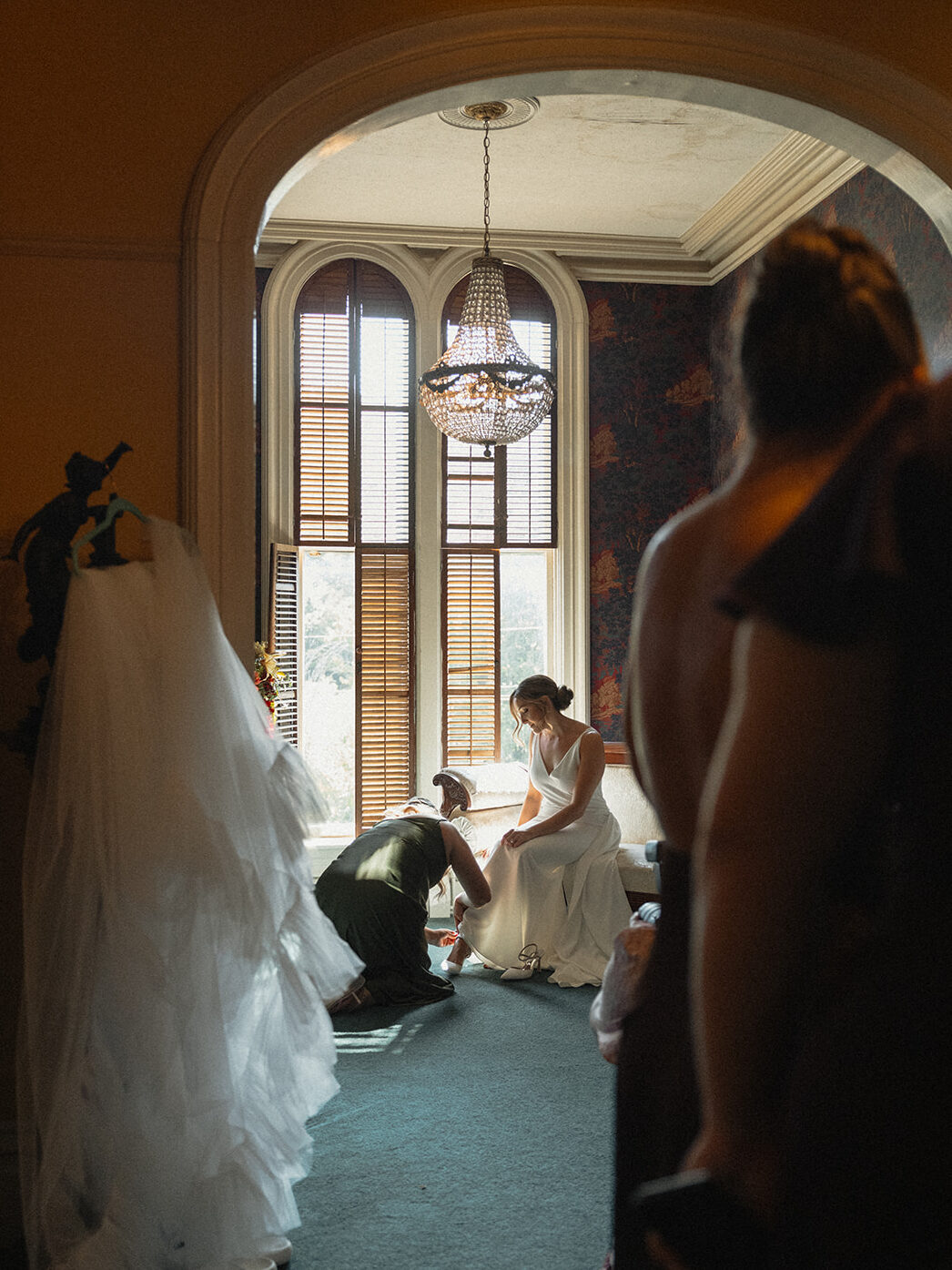 bride getting dressed with bridesmaids