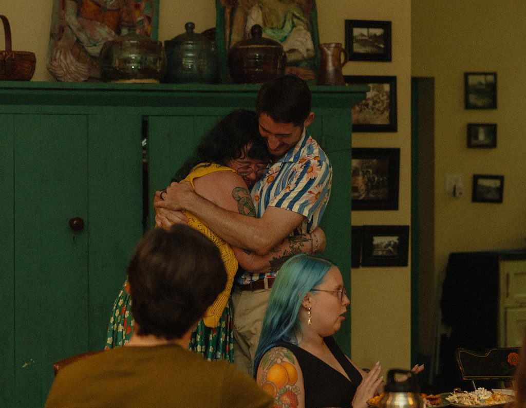 hug from maid of honor at rehearsal dinner