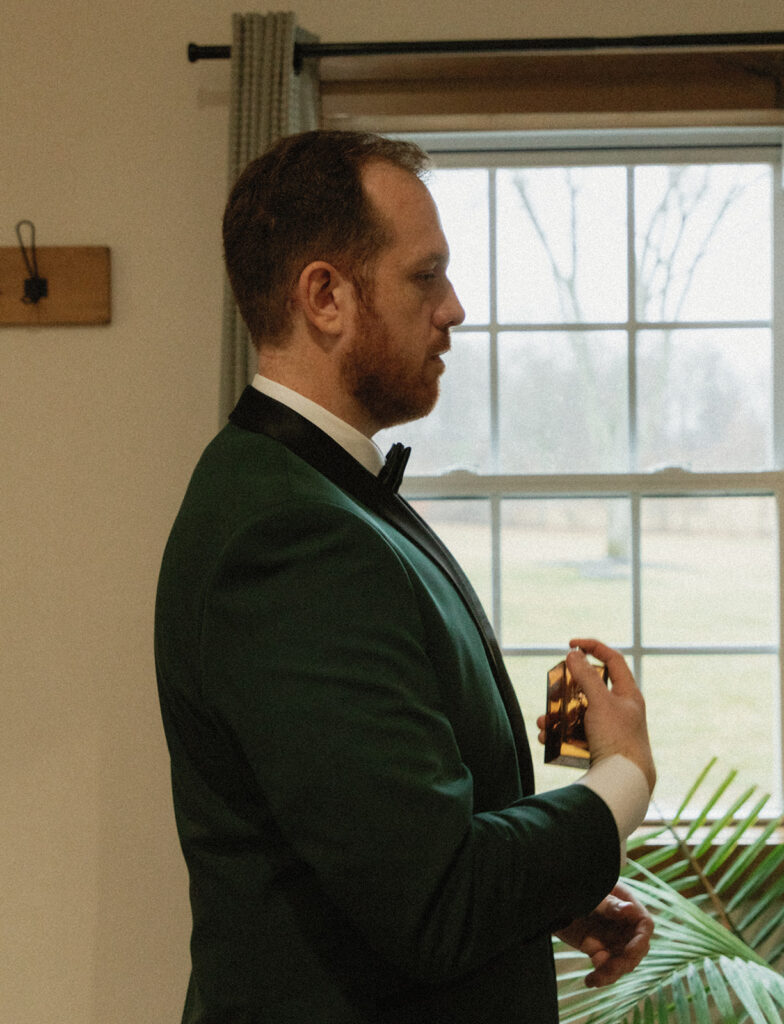 groom putting on cologne